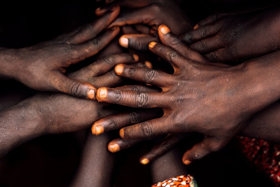 Hands of African village kids.